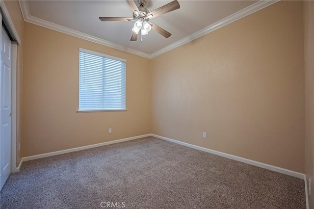 carpeted empty room featuring ceiling fan and ornamental molding