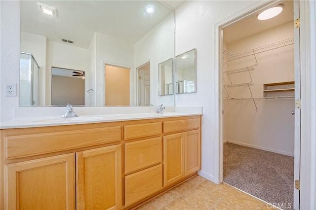 bathroom featuring vanity and a shower with shower door