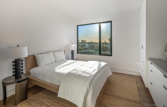 bedroom with dark hardwood / wood-style flooring