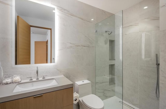 bathroom featuring vanity, toilet, decorative backsplash, and a tile shower