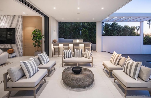 view of patio / terrace featuring an outdoor living space, a pergola, and an outdoor bar