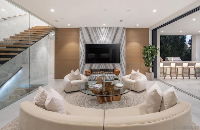 living room with floor to ceiling windows and a premium fireplace