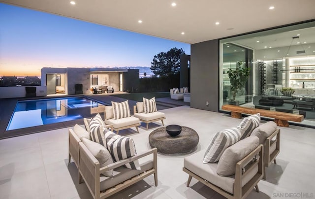 patio terrace at dusk featuring an outdoor living space