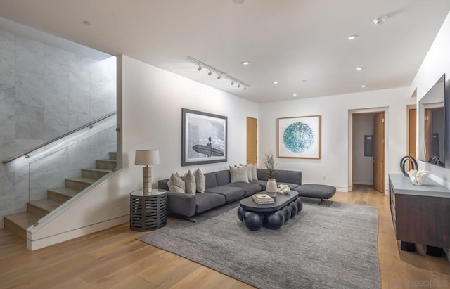 living room with track lighting and light hardwood / wood-style floors