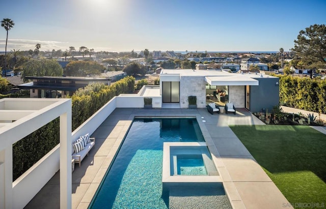 view of swimming pool featuring an in ground hot tub, a patio, and a lawn