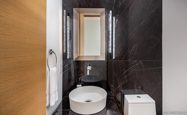 bathroom with tile walls and toilet