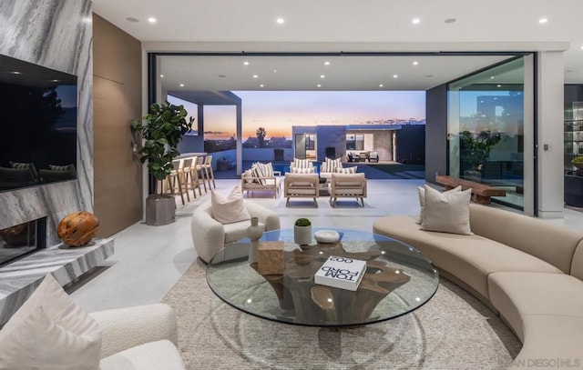 living room featuring a premium fireplace and expansive windows