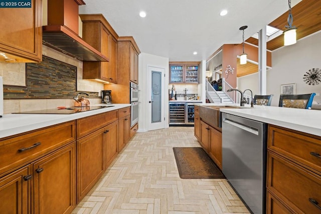 kitchen with appliances with stainless steel finishes, range hood, backsplash, hanging light fixtures, and light parquet flooring