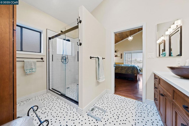 bathroom with tile patterned flooring, vanity, lofted ceiling, and walk in shower