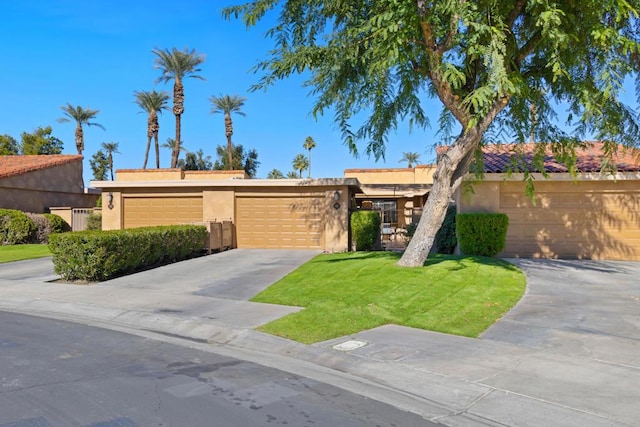 view of front of home featuring a garage and a front lawn