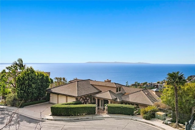 view of front facade with a water view and a garage