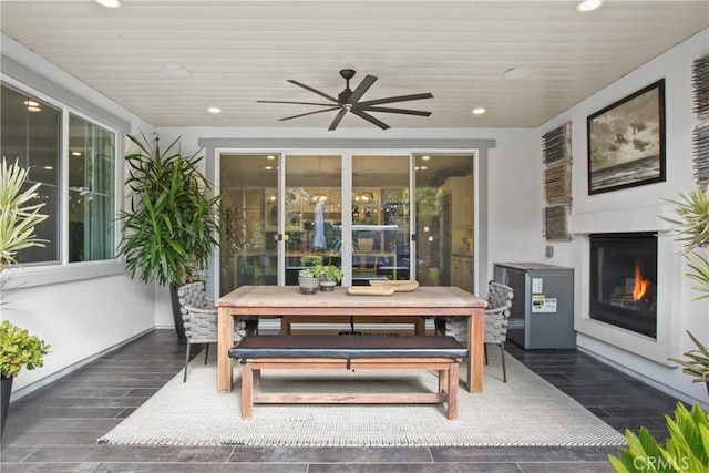 sunroom / solarium featuring an outdoor fireplace