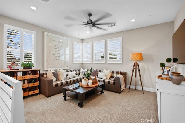 living room with light colored carpet and ceiling fan