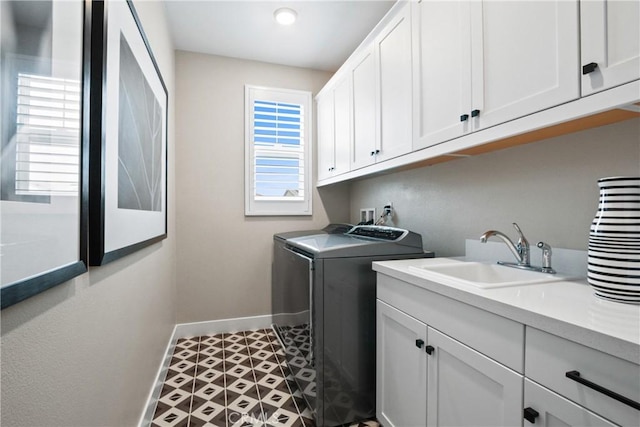 laundry room featuring hookup for a washing machine, sink, and cabinets