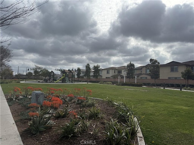 view of property's community featuring a playground and a yard