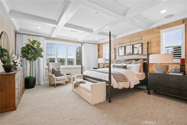 bedroom featuring wooden walls, coffered ceiling, ornamental molding, light colored carpet, and beamed ceiling