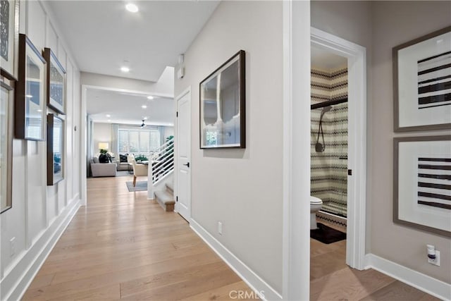 corridor with light hardwood / wood-style flooring