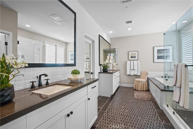 bathroom featuring tile patterned floors, vanity, independent shower and bath, and backsplash