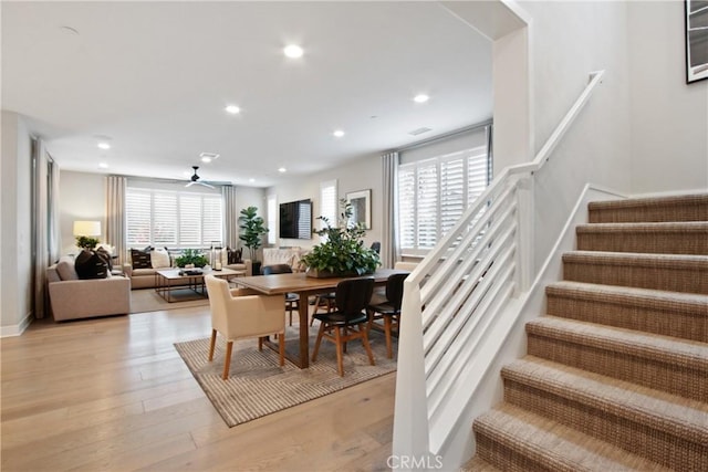 dining room with ceiling fan and light hardwood / wood-style flooring