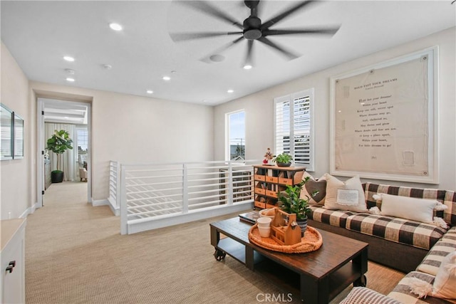 carpeted living room featuring ceiling fan