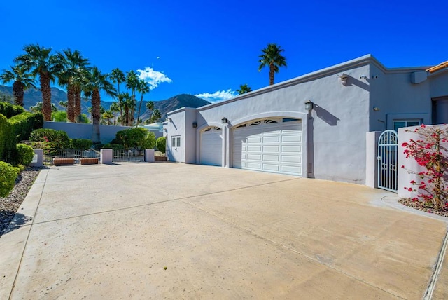 view of side of property with a garage and a mountain view