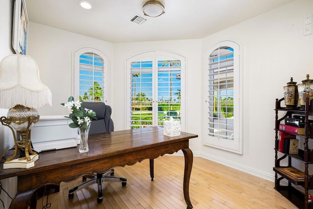 office with light hardwood / wood-style floors