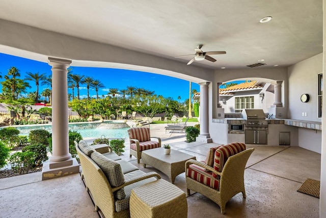 view of patio / terrace with exterior kitchen, area for grilling, a fenced in pool, and ceiling fan