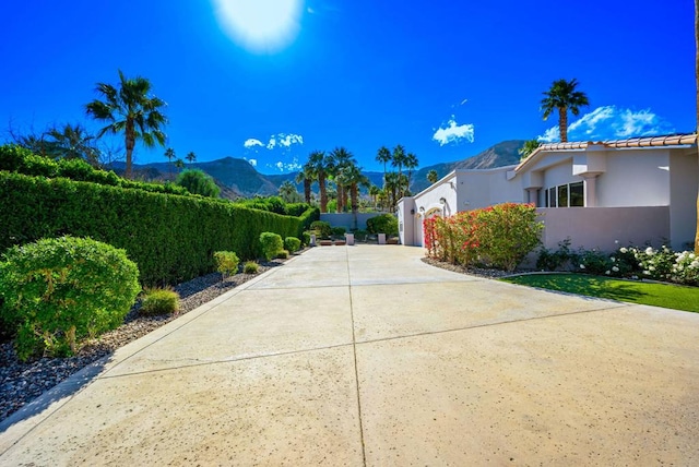 view of side of property featuring a garage and a mountain view