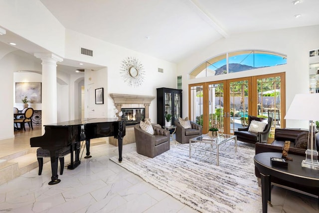 interior space with beamed ceiling, high vaulted ceiling, a high end fireplace, and decorative columns