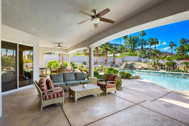 view of patio / terrace featuring ceiling fan, an outdoor living space, and a fenced in pool