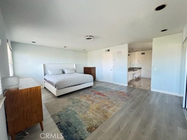 bedroom featuring baseboards and wood finished floors