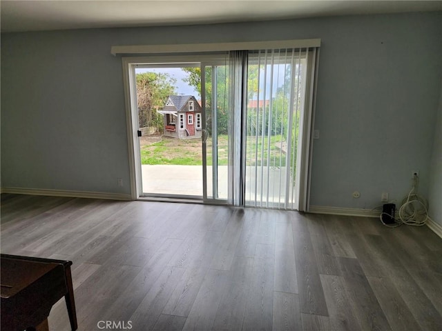 interior space featuring wood finished floors and baseboards