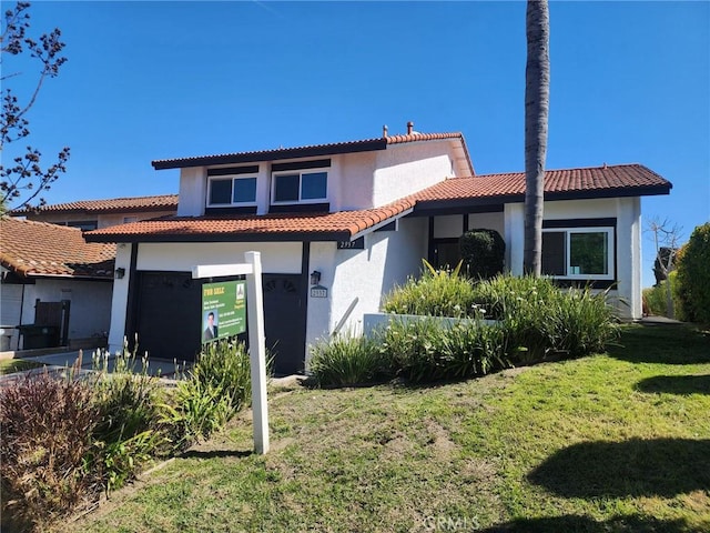 rear view of property with stucco siding, a tiled roof, a lawn, and concrete driveway