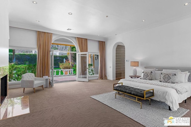 carpeted bedroom featuring ornamental molding and access to exterior