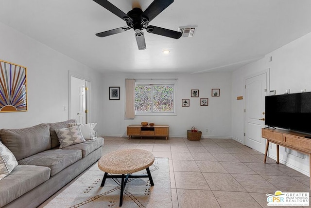 tiled living room featuring ceiling fan