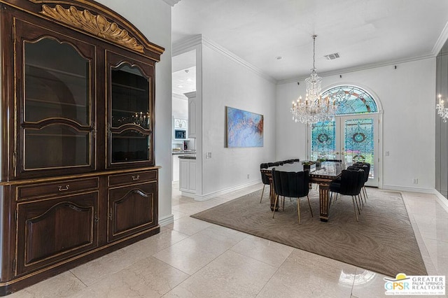 dining space featuring ornamental molding and an inviting chandelier