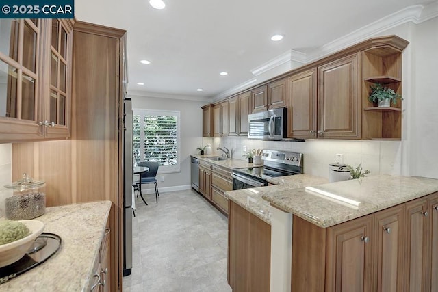 kitchen with crown molding, tasteful backsplash, appliances with stainless steel finishes, kitchen peninsula, and light stone countertops