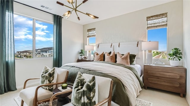 16650 Crocus Ln Unit 1, Fontana, CA 92336 - bedroom with a chandelier, carpet floors, and multiple windows
