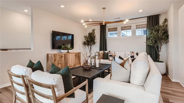 living room with hardwood / wood-style flooring and a chandelier