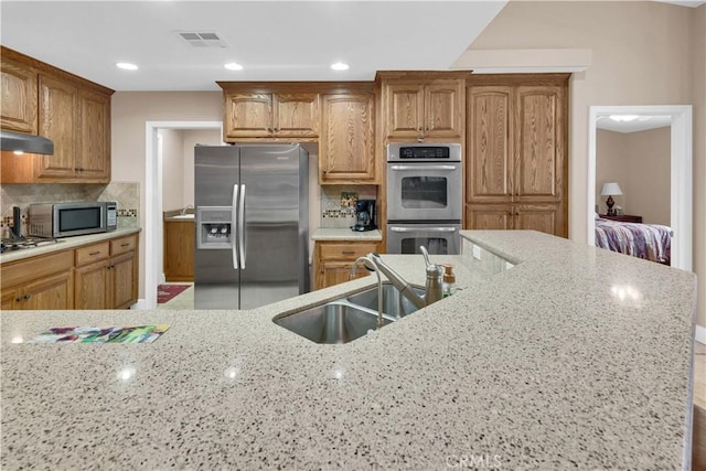 4653 Tumbleweed Way, Paso Robles, CA 93446 - kitchen with light stone counters, tasteful backsplash, a sink, visible vents, and stainless steel appliances