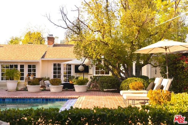 back of property with a patio area and french doors