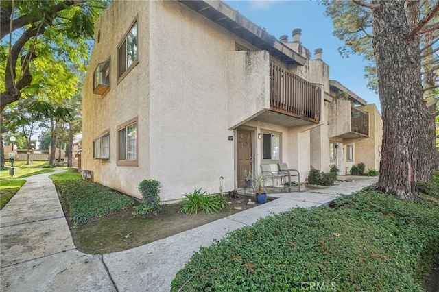 view of side of property featuring a balcony