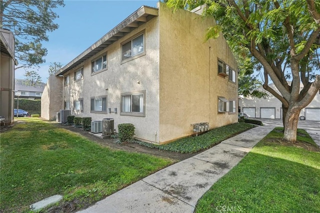 view of home's exterior with central AC unit and a yard