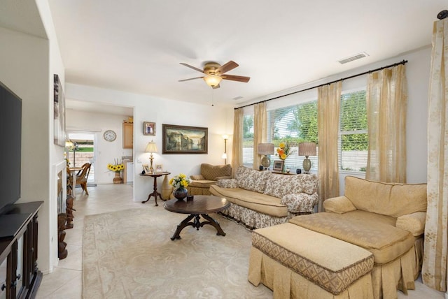 tiled living room featuring ceiling fan