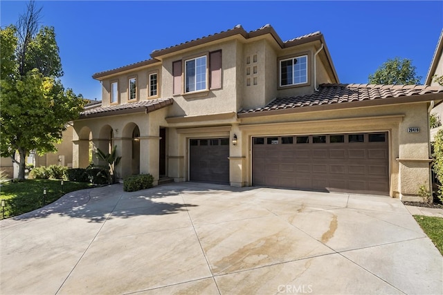 mediterranean / spanish house featuring a garage