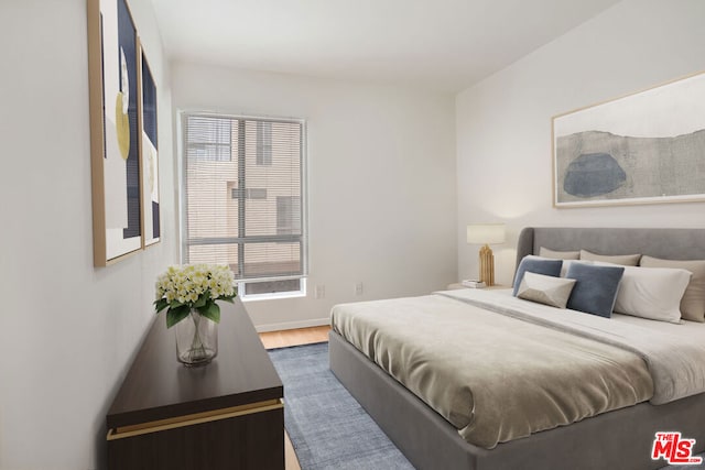 bedroom with hardwood / wood-style flooring