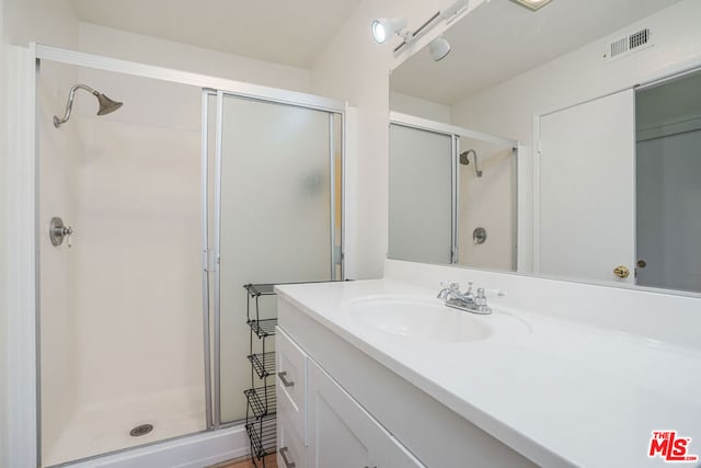 bathroom featuring vanity and walk in shower