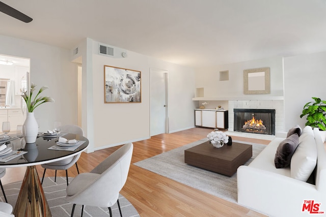 living room featuring light hardwood / wood-style flooring and a fireplace