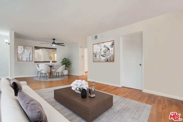 living room with hardwood / wood-style flooring and ceiling fan