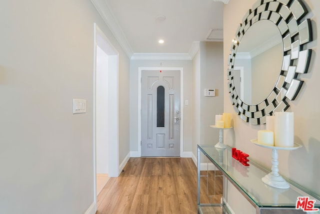 interior space featuring ornamental molding and light hardwood / wood-style floors